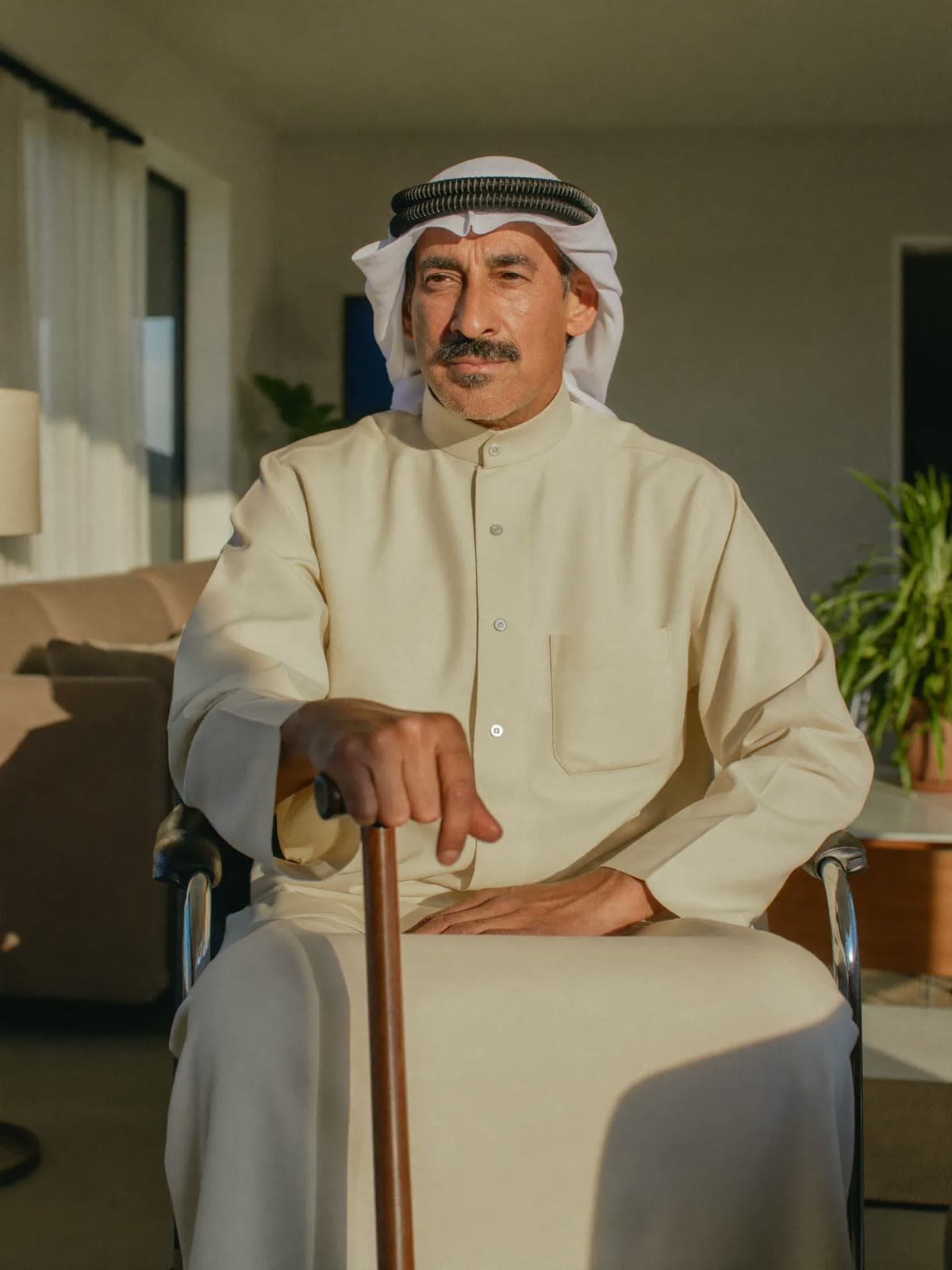 Khalid, 62, the fictional demonstration patient, at home with his cane